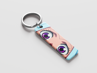 Keychain with anime-style character design on a light gray background